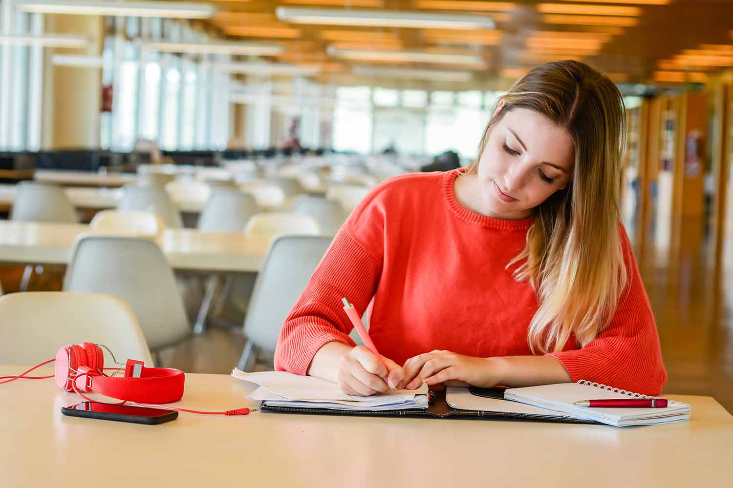 Happy female adult student passing online test